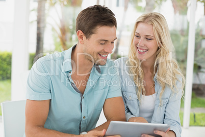 Hip young couple using tablet together Hip young couple using tablet together