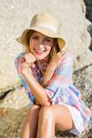 Pretty blonde smiling at camera at the beach