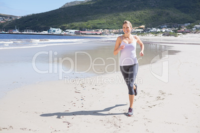 Pretty blonde jogging on the beach