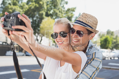 Young hip couple taking a selfie