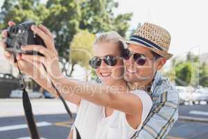 Young hip couple taking a selfie