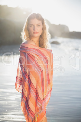 Beautiful blonde wrapped in scarf at the beach