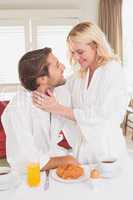 Couple having breakfast in their bathrobes