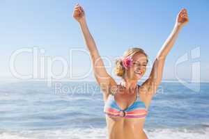 Gorgeous blonde in bikini on the beach smiling