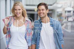 Cute young couple walking with shopping bags