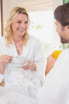 Couple having breakfast in their bathrobes