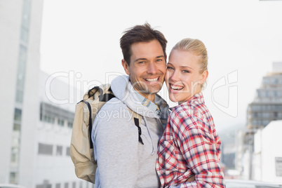 Hip young couple smiling at camera