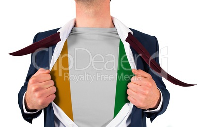 Businessman opening shirt to reveal ivory coast flag