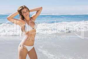 Beautiful fit woman in white bikini on the beach