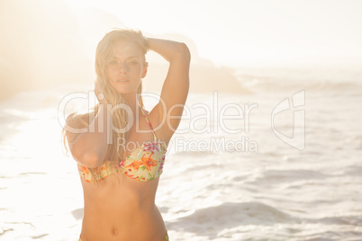 Gorgeous blonde in floral bikini posing at the beach