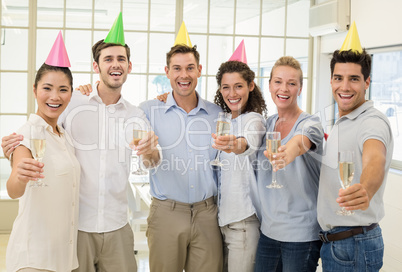 Casual business team celebrating with champagne