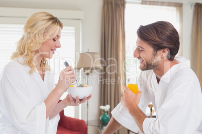 Couple having breakfast in their bathrobes