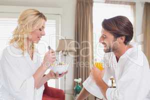 Couple having breakfast in their bathrobes