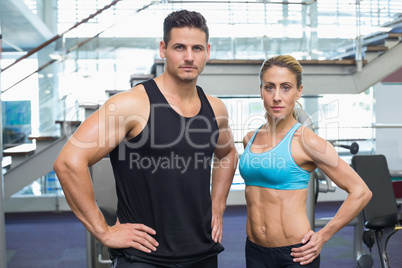 Bodybuilding man and woman frowning at camera