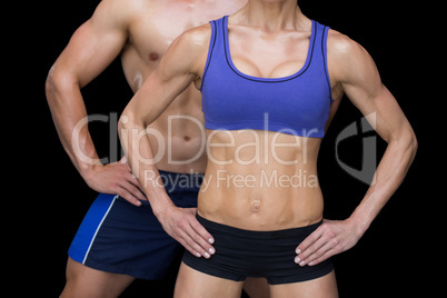 Crossfit couple posing with hands on hips