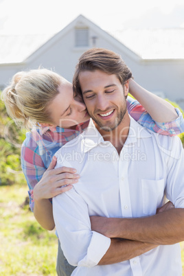 Cute couple standing together in their garden