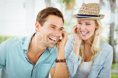 Hip young couple listening to music together