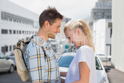 Hip young couple smiling at each other