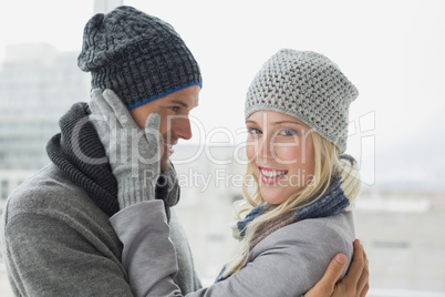 Cute couple in warm clothing hugging