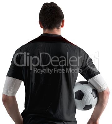 Football player in black holding ball