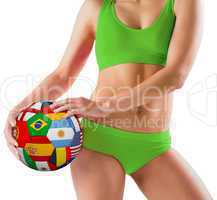 Fit girl in green bikini holding flag ball