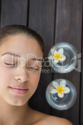 Peaceful brunette lying with eyes closed