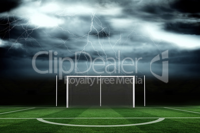 Football pitch under stormy sky