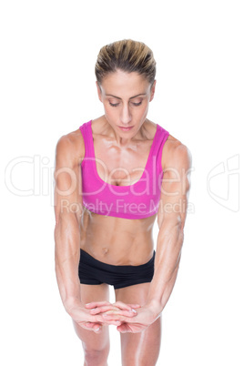 Female bodybuilder flexing with hands together