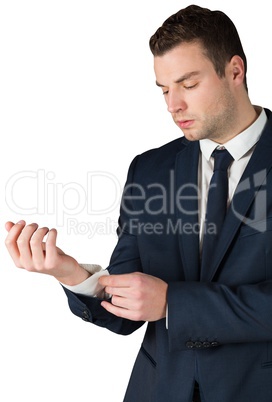 Businessman adjusting his cuffs on shirt