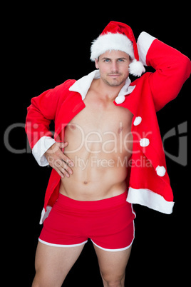 Muscular man posing in sexy santa outfit