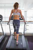 Fit woman walking on the treadmill
