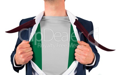 Businessman opening shirt to reveal nigeria flag