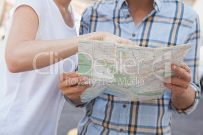 Young tourist couple looking at map