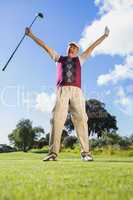 Excited golfer cheering and looking at camera