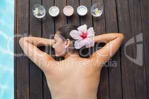 Tranquil brunette poolside with beauty treatments