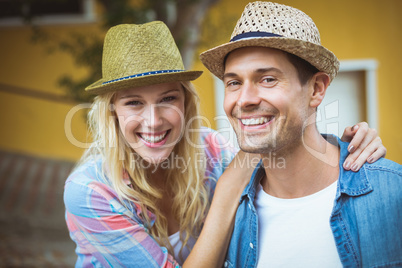 Hip young couple smiling at camera