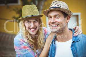 Hip young couple smiling at camera