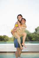 Gorgeous couple having fun poolside on holidays