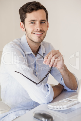 Casual businessman sitting at his desk