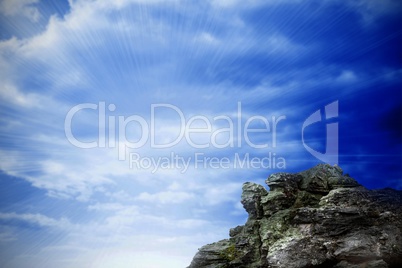 Large rock overlooking bright blue sky