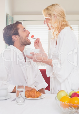 Couple having breakfast in their bathrobes