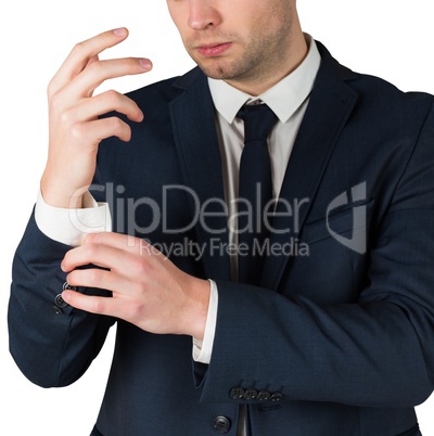 Handsome businessman adjusting his cuffs