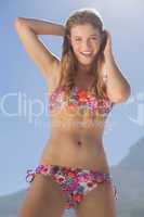 Smiling blonde in floral bikini on the beach