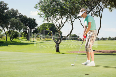 Female golfer putting her ball