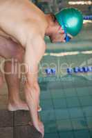 Fit swimmer ready to dive into the pool