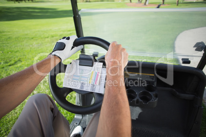 Golfer driving his golf buggy forward