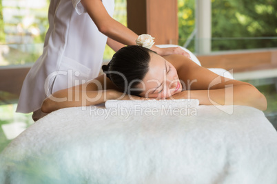 Brunette enjoying a peaceful massage with eyes closed