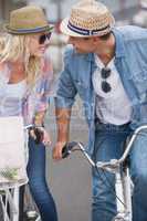 Hip young couple going for a bike ride