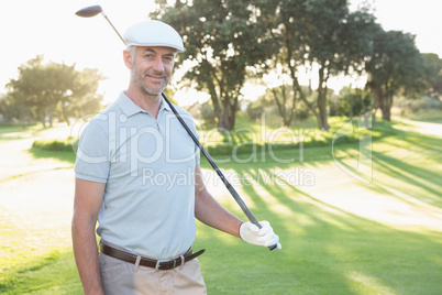 Smiling handsome golfer looking at camera