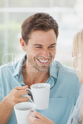 Cute couple having coffee together in cafe